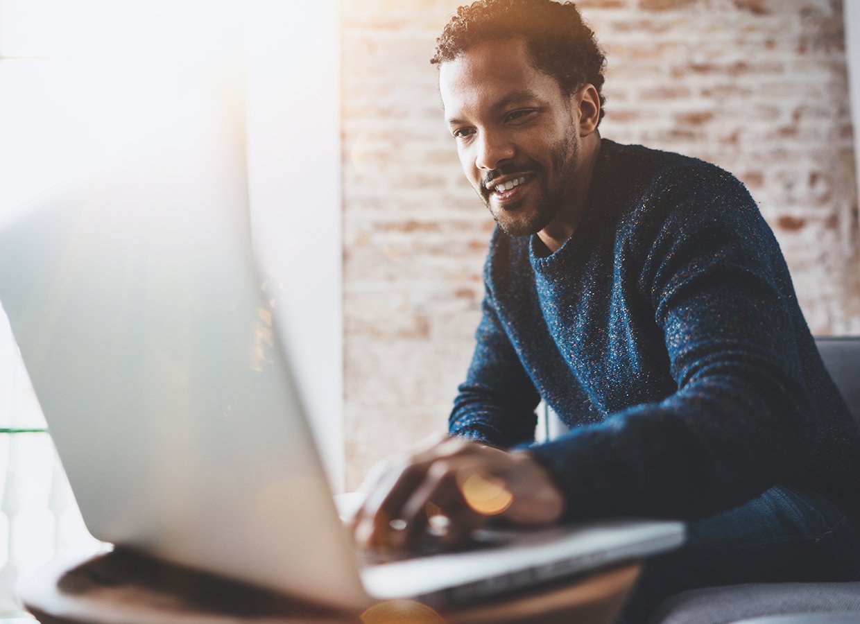 Man sitting on sofa with laptop